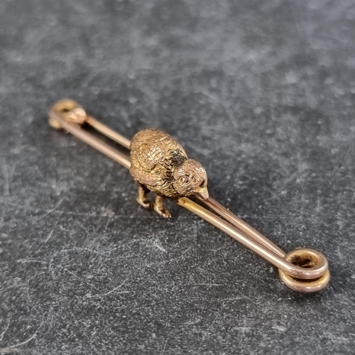 280 - A yellow metal 'chick' bar brooch, stamped '9ct', 42mm wide.