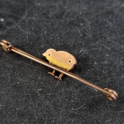 280 - A yellow metal 'chick' bar brooch, stamped '9ct', 42mm wide.