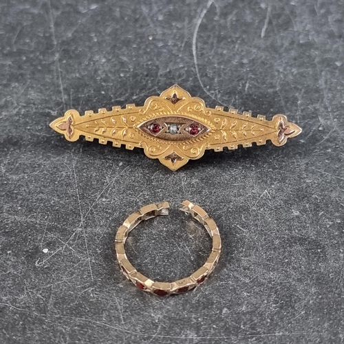 282 - An Edwardian yellow metal bar brooch, set with central seed pearl flanked by two rubies, stamped 9ct... 