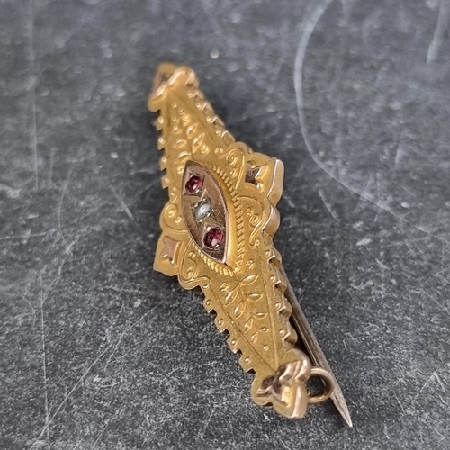 282 - An Edwardian yellow metal bar brooch, set with central seed pearl flanked by two rubies, stamped 9ct... 