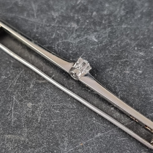 283 - A white metal bar brooch set, central claw set diamond of approximately 0.2ct, stamped '9ct/plat', 6... 