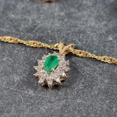 294 - A yellow metal pendant, set central emerald surrounded by diamonds, stamped 14k, 13mm high, on an It... 