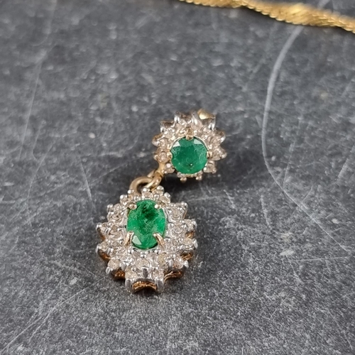 294 - A yellow metal pendant, set central emerald surrounded by diamonds, stamped 14k, 13mm high, on an It... 