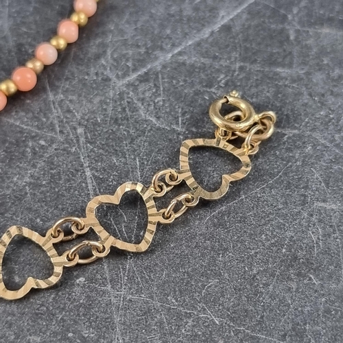 295 - A 9ct gold 'heart' bracelet, London 1977, 18cm, 3.1g; together a 9ct gold and coral bead necklace, 4... 