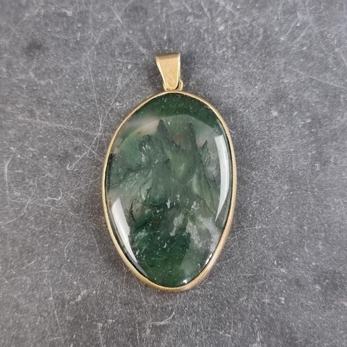 297 - A gilt metal moss agate pendant, 52mm high including bale.