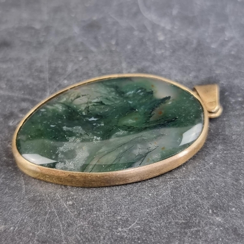 297 - A gilt metal moss agate pendant, 52mm high including bale.