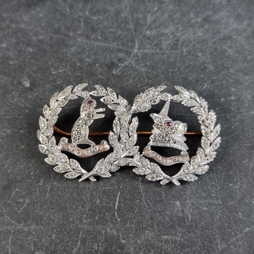 299 - A white metal diamond and ruby 'Argyll & Sutherland Highlanders' sweetheart brooch, 51mm wide.... 