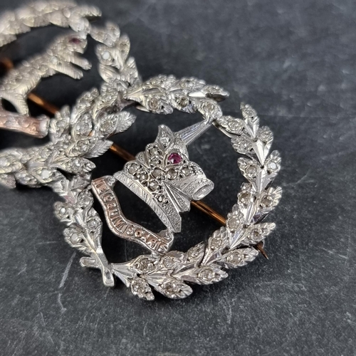 299 - A white metal diamond and ruby 'Argyll & Sutherland Highlanders' sweetheart brooch, 51mm wide.... 