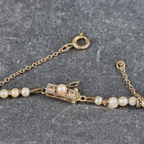 301 - A pearl necklace, having yellow metal clasp set two small diamonds and a pearl, 43cm long.... 