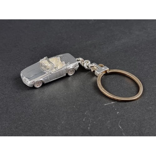 304 - A silver Mercedes Benz SLK keyring, stamped 925, London 2003, the car 43mm, overall 110mm.... 