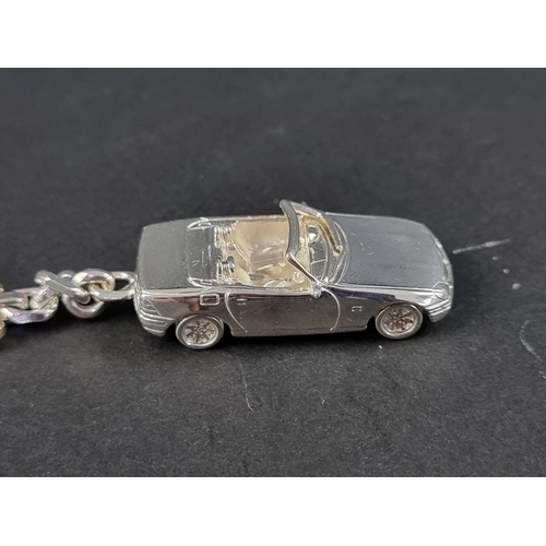 304 - A silver Mercedes Benz SLK keyring, stamped 925, London 2003, the car 43mm, overall 110mm.... 