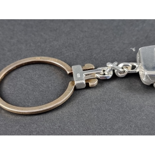 304 - A silver Mercedes Benz SLK keyring, stamped 925, London 2003, the car 43mm, overall 110mm.... 