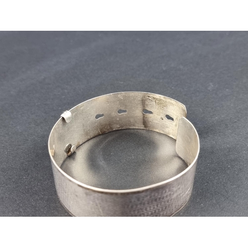 308 - An engine turned white metal adjustable cuff bracelet, by Joseph Smith & Sons (Birmingham) Ltd, ... 