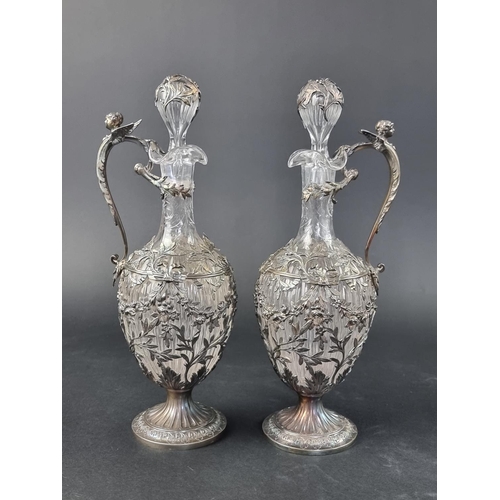 32 - A good pair of late 19th/early 20th century French silver mounted cut glass claret jugs, with .950 s... 