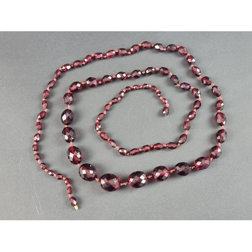 322 - A cherry amber style faceted bead necklace, having seventy three beads of approximately 5-16mm diame... 