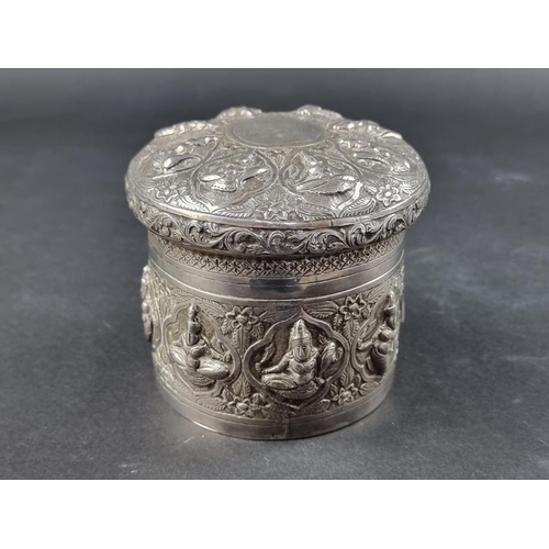 33 - An Eastern white metal cylindrical lidded box, probably Indian or Burmese, 9cm high, 11cm diameter.... 