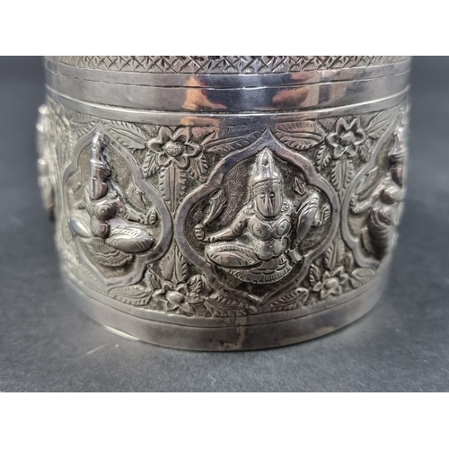 33 - An Eastern white metal cylindrical lidded box, probably Indian or Burmese, 9cm high, 11cm diameter.... 