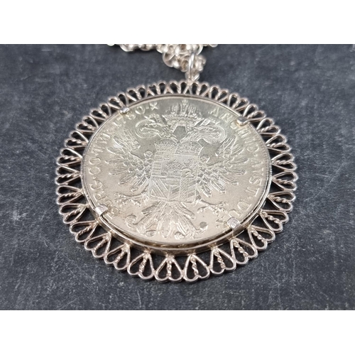 426 - Coins: a Maria Theresa 1780 silver thaler, in a white metal pendant mount, 55mm, with chain, stamped... 