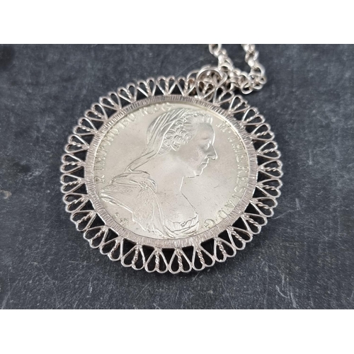 426 - Coins: a Maria Theresa 1780 silver thaler, in a white metal pendant mount, 55mm, with chain, stamped... 