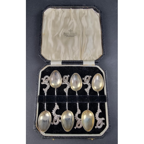 51 - A cased set of six Chinese white metal spoons, having dragon terminals, probably by Wang Hing.... 