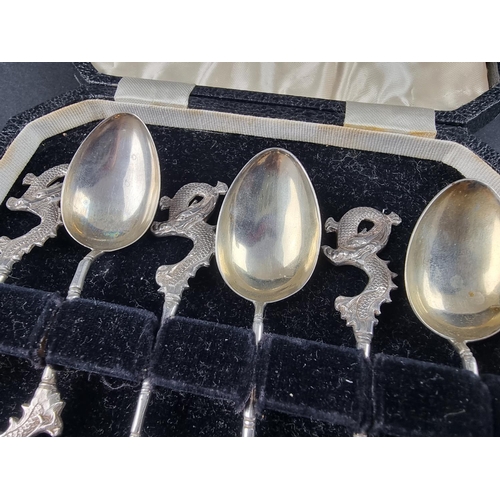 51 - A cased set of six Chinese white metal spoons, having dragon terminals, probably by Wang Hing.... 