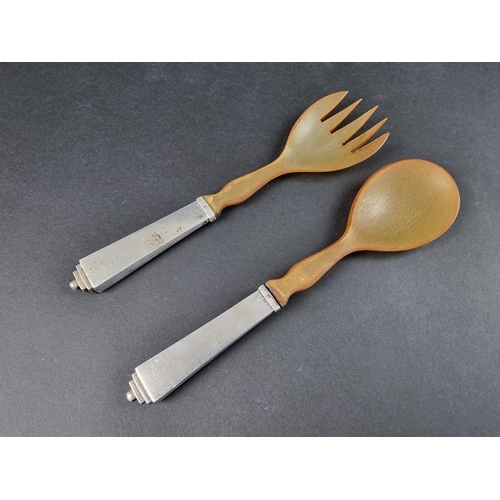 64 - A pair of silver mounted horn salad servers, by Georg Jensen Ltd, import mark London 1936.... 