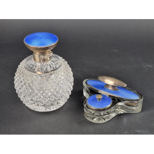 71 - A silver and guilloche enamel mounted cut glass scent bottle, 13cm high; together with a similar nai... 