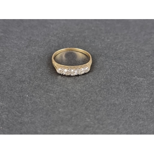 144 - A yellow metal ring set, with five graduated old cut diamonds, size O.