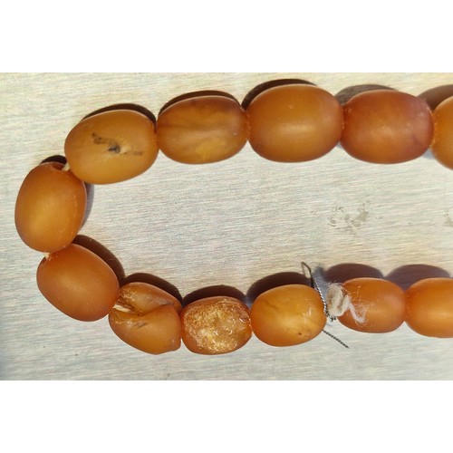 317 - A graduated amber bead necklace, 64cm long, gross weight 52.8g.