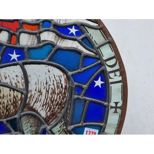 1379 - An old stained and leaded glass 'Lamb & Flag' circular panel, 54cm diameter.