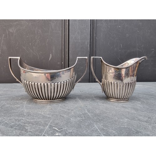 80 - A silver cream jug and matching sugar bowl, by William Hutton & Sons Ltd, London 1904, heig... 