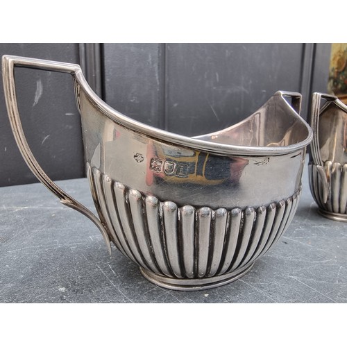 80 - A silver cream jug and matching sugar bowl, by William Hutton & Sons Ltd, London 1904, heig... 