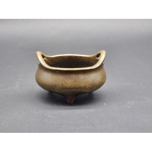 1428 - A Chinese bronze twin handled tripod censer, Xuande six character seal mark to base, 12cm diame... 