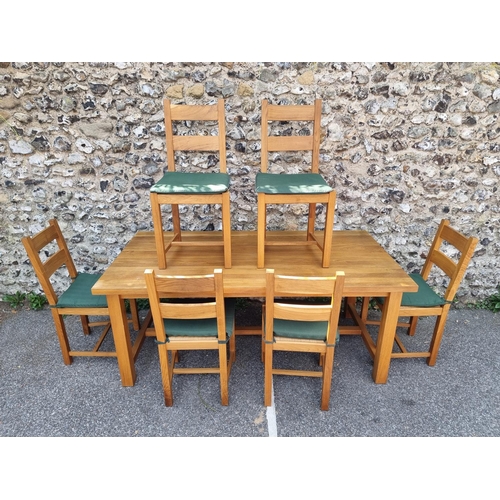 1003 - A contemporary oak dining table and six matching chairs, the table 180 x 90.5cm.... 