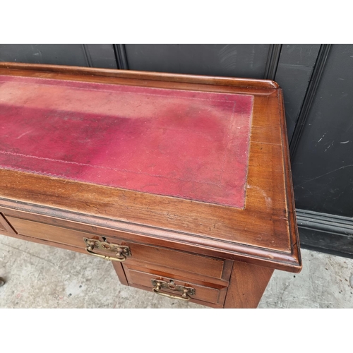 1005 - A late Victorian walnut kneehole desk, 107cm wide.