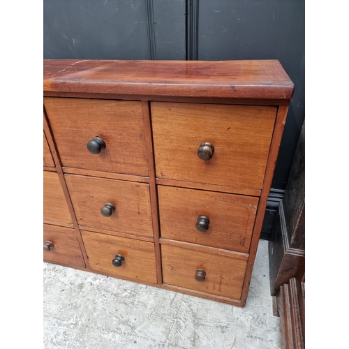 1008 - A vintage mahogany multi-drawer chest, 63.5cm high x 181.5cm wide x 31.5cm deep.