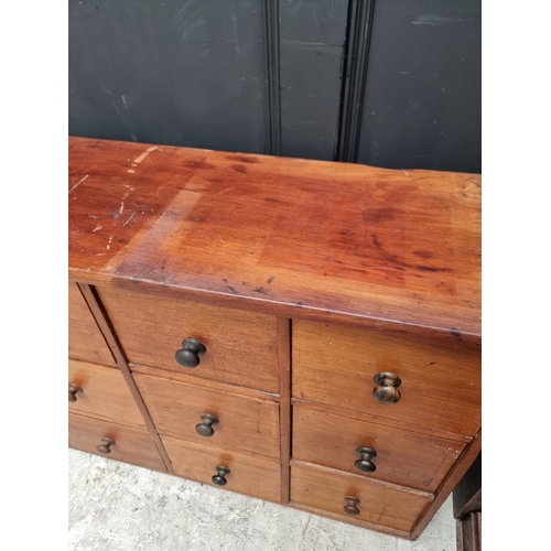 1008 - A vintage mahogany multi-drawer chest, 63.5cm high x 181.5cm wide x 31.5cm deep.