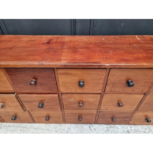 1008 - A vintage mahogany multi-drawer chest, 63.5cm high x 181.5cm wide x 31.5cm deep.