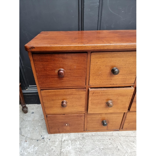 1008 - A vintage mahogany multi-drawer chest, 63.5cm high x 181.5cm wide x 31.5cm deep.