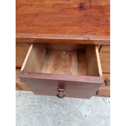 1008 - A vintage mahogany multi-drawer chest, 63.5cm high x 181.5cm wide x 31.5cm deep.