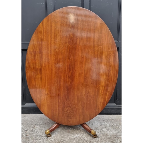 1019 - A 19th century mahogany oval tilt-top breakfast table, on reeded outswept legs, 152.5cm wide.... 