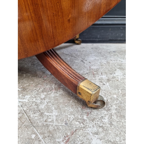 1019 - A 19th century mahogany oval tilt-top breakfast table, on reeded outswept legs, 152.5cm wide.... 