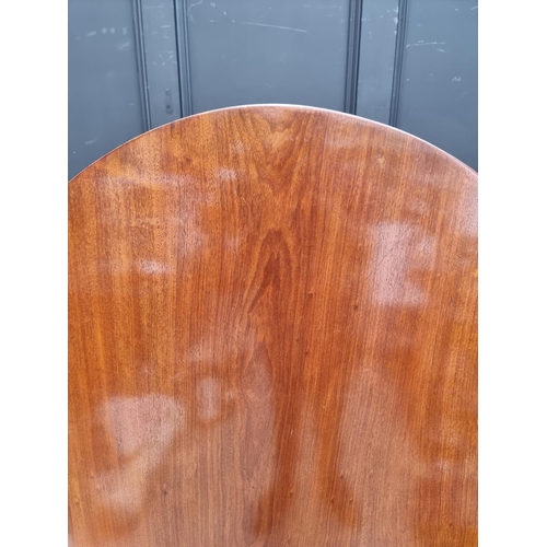 1019 - A 19th century mahogany oval tilt-top breakfast table, on reeded outswept legs, 152.5cm wide.... 