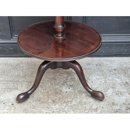 1022 - A George III mahogany two-tier dumb waiter, on concealed brass casters, 57cm diameter, (alterat... 