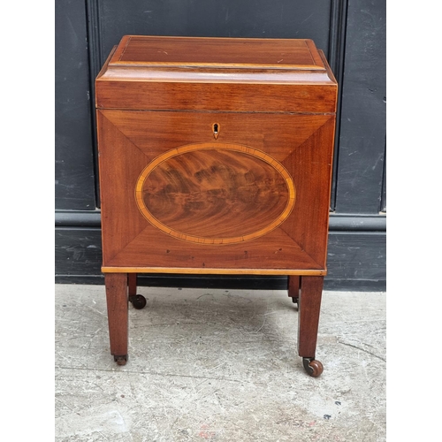 1023 - A small George III mahogany and inlaid cellarette, 38cm wide.