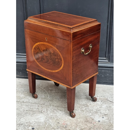 1023 - A small George III mahogany and inlaid cellarette, 38cm wide.