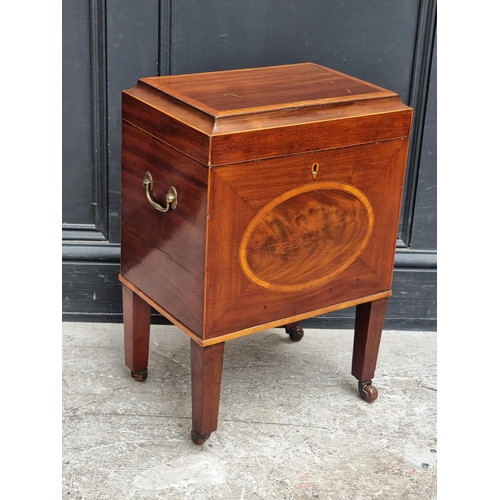 1023 - A small George III mahogany and inlaid cellarette, 38cm wide.