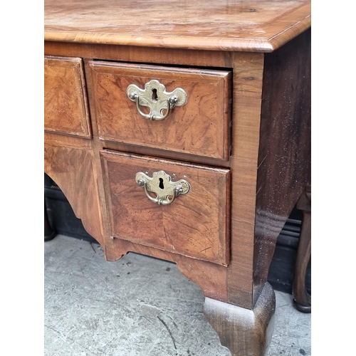 1027 - A George II walnut, feather and crossbanded lowboy, 88cm wide.