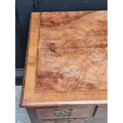 1027 - A George II walnut, feather and crossbanded lowboy, 88cm wide.