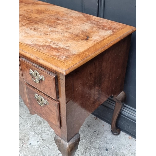 1027 - A George II walnut, feather and crossbanded lowboy, 88cm wide.